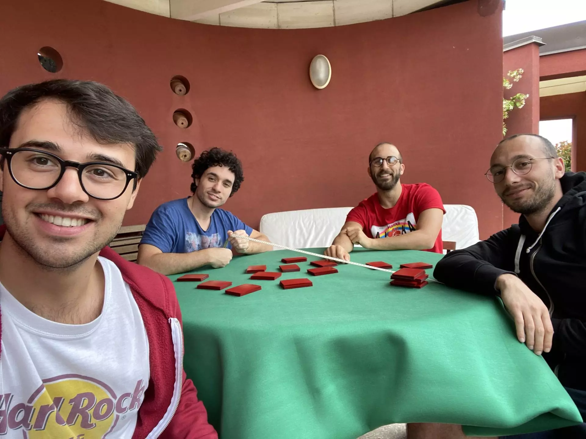 Group-Selfie of Andrea Mengucci with his Magic: The Gathering Community sitting by Table